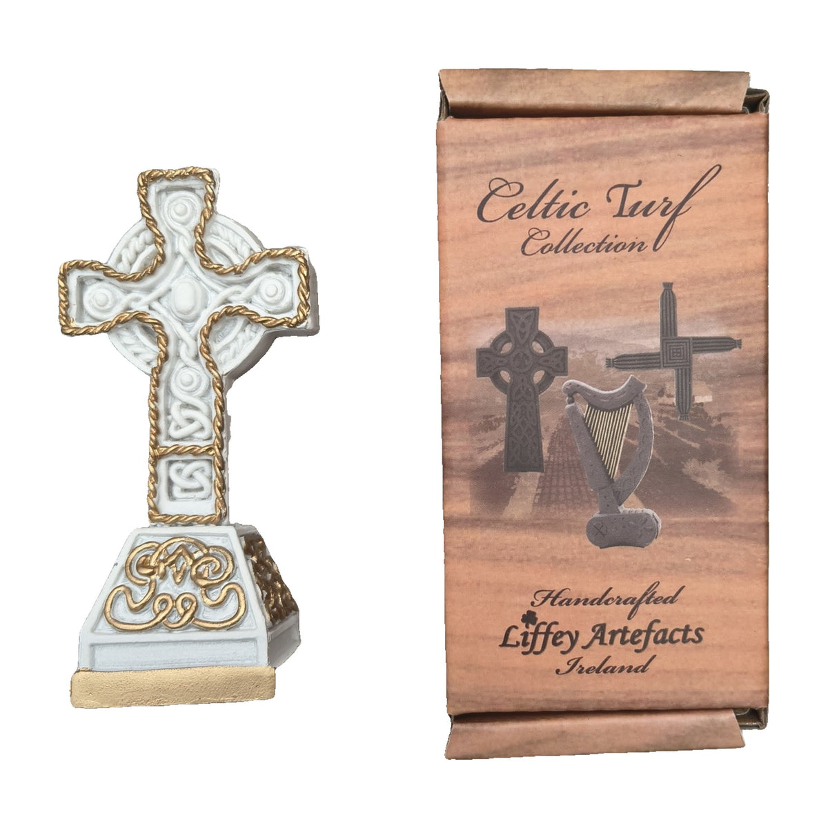 Small ornate white and gold turf Celtic cross with box